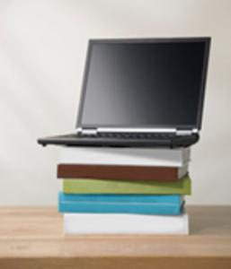 laptop on book pile